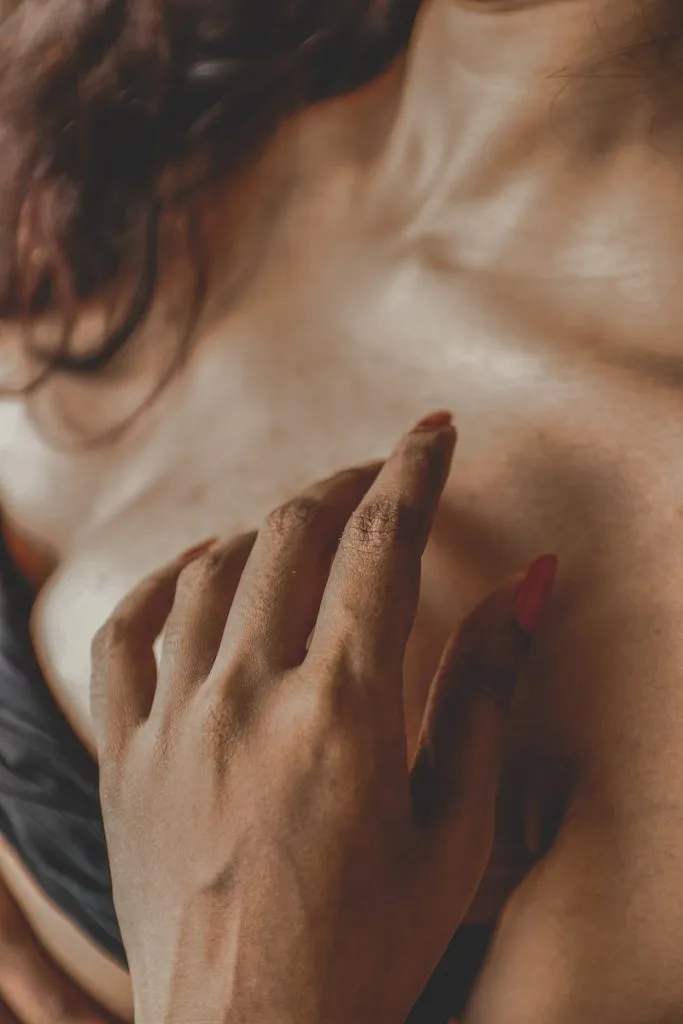 Anonymous lady touching breast sensually